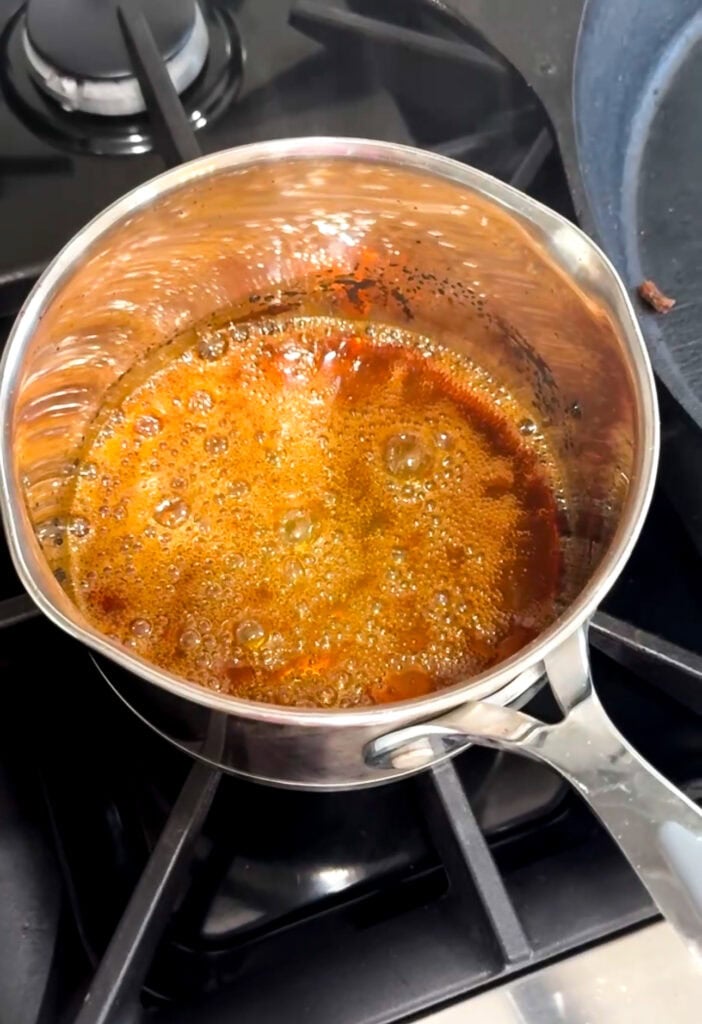 sugar caramelizing in a saucepan on the stove