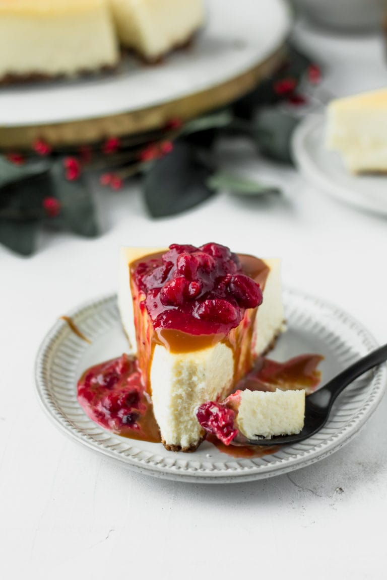 cheesecake with caramel and cranberry topping