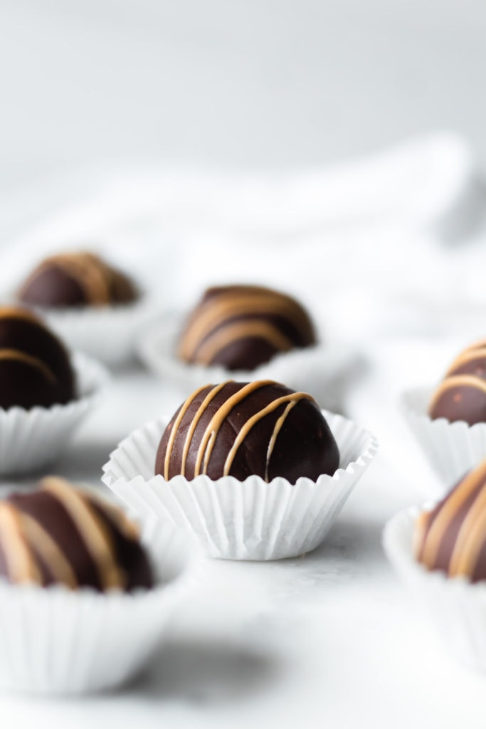cookie dough truffles with chocolate coating and sunbutter drizzle