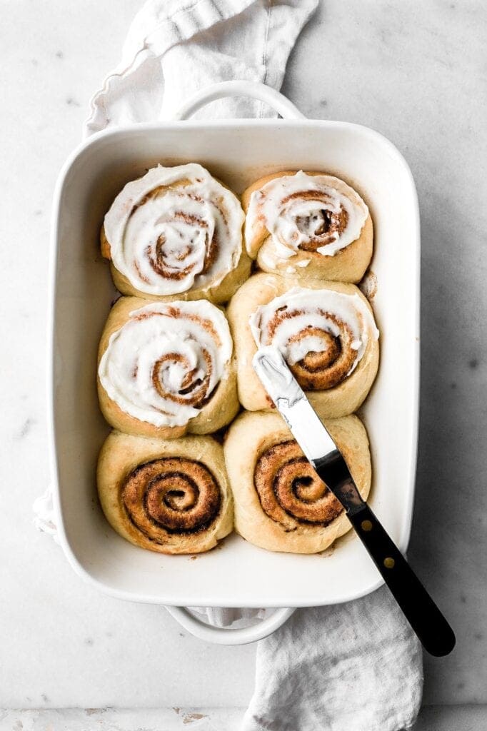 brioche cinnamon rolls baked in pan with cream cheese frosting