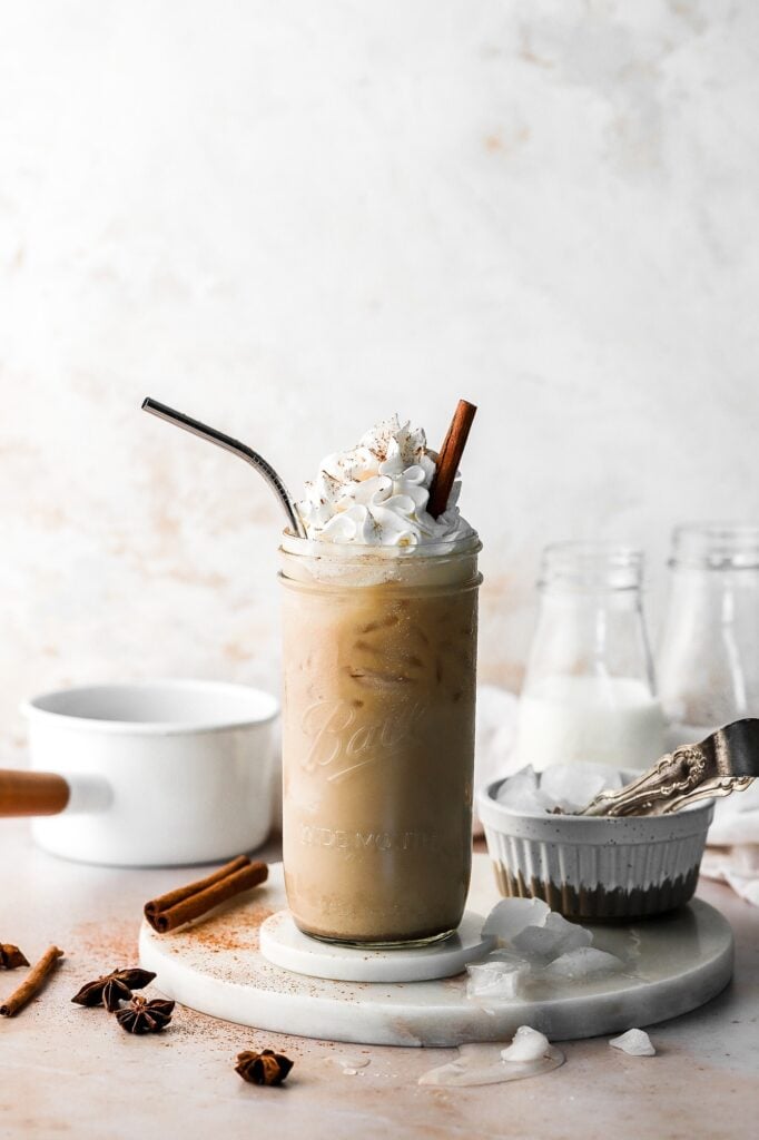 chai latte, iced with whipped cream and cinnamon