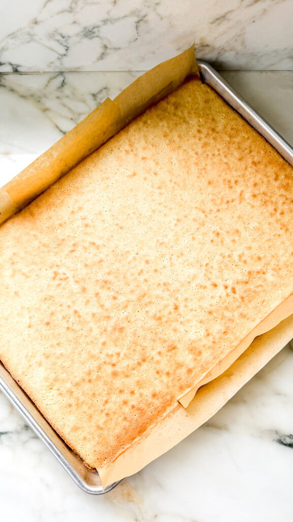Baked sponge cake base for French Opera Cake on baking sheet.