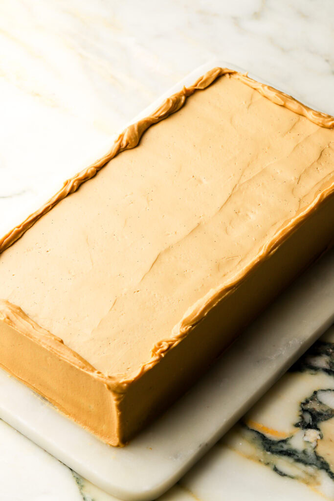 whole opera cake frosted with coffee french buttercream