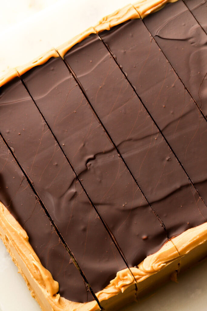 close up of chocolate glaze on opera cake slices next to each other.