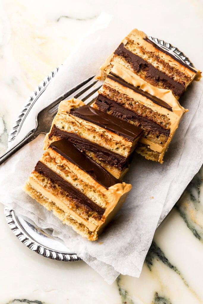 four slices of opera cake in a tray with a fork