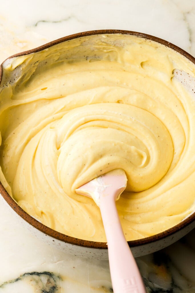 pastry cream with whipped cream folded in, in a bowl with a spatula