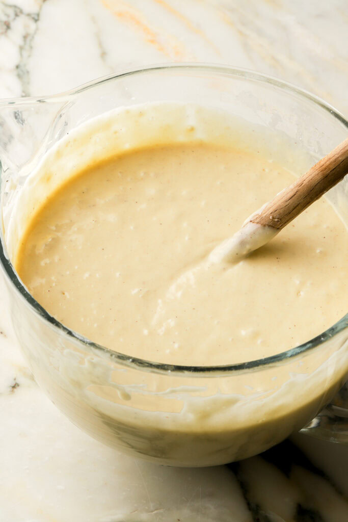 finished cake batter in a glass bowl with spatula in bowl