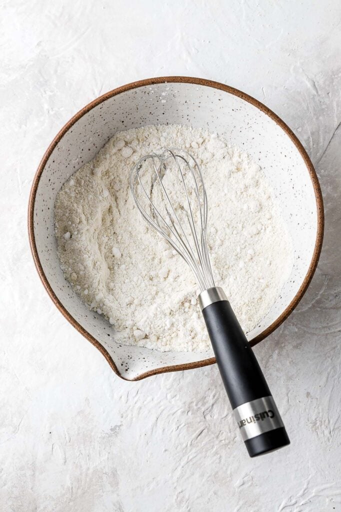 whisk together almond flour and powdered sugar