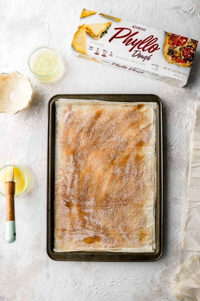top layer of phyllo dough with egg whites and cinnamon sugar