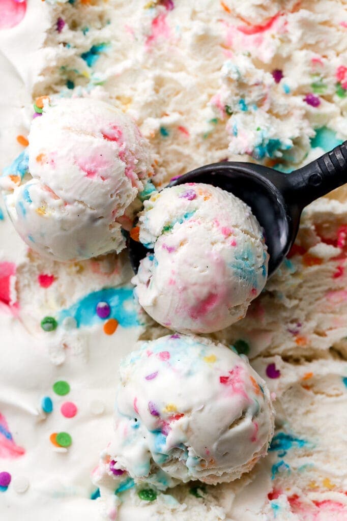 no churn cotton candy ice cream with sprinkles and a scooper