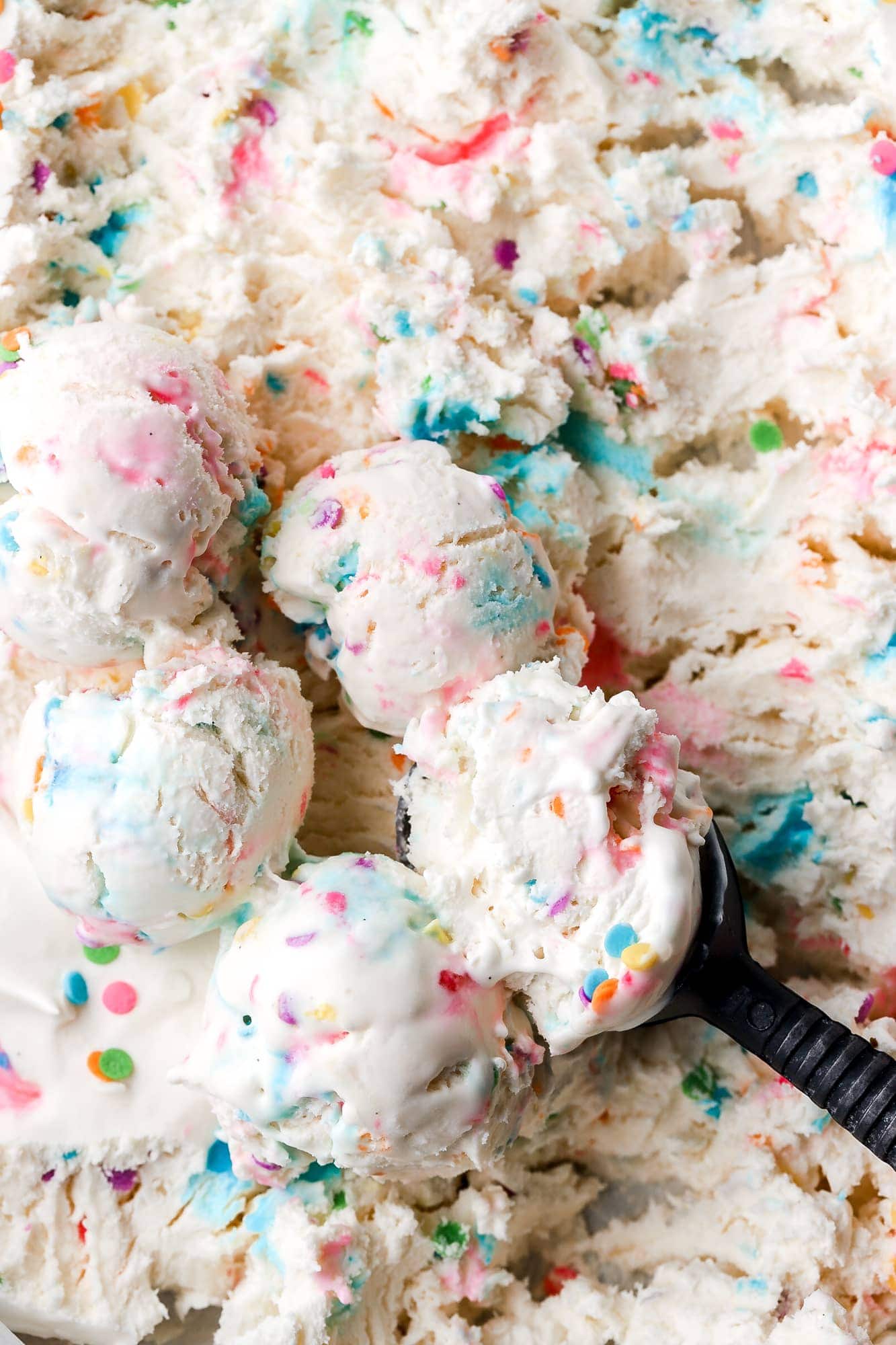 Bulk Ice Cream Kept in Large Round Containers Behind Glass at