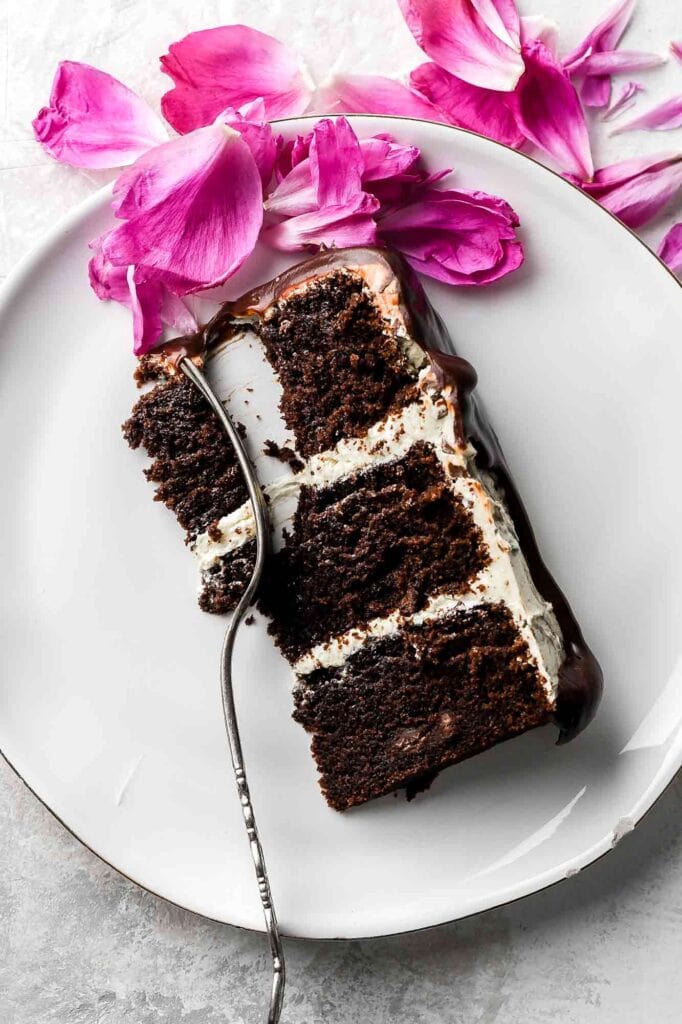 Chocolate Almond Cake slice with fork and pink petals