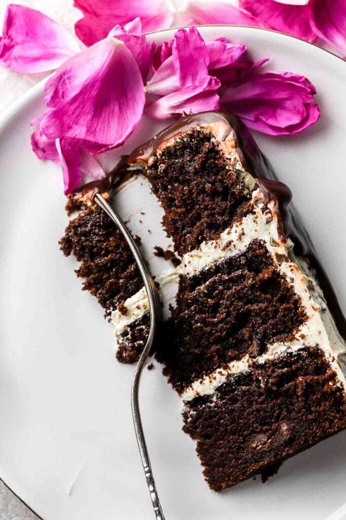 close up of slice of chocolate cake with almond buttercream