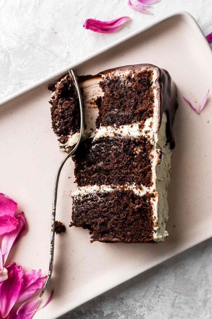 chocolate chip almond cake slice with fork and pink petals