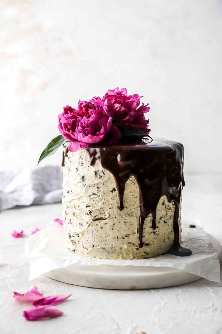 Chocolate Chip Almond Cake with chocolate ganache drip and pink flower