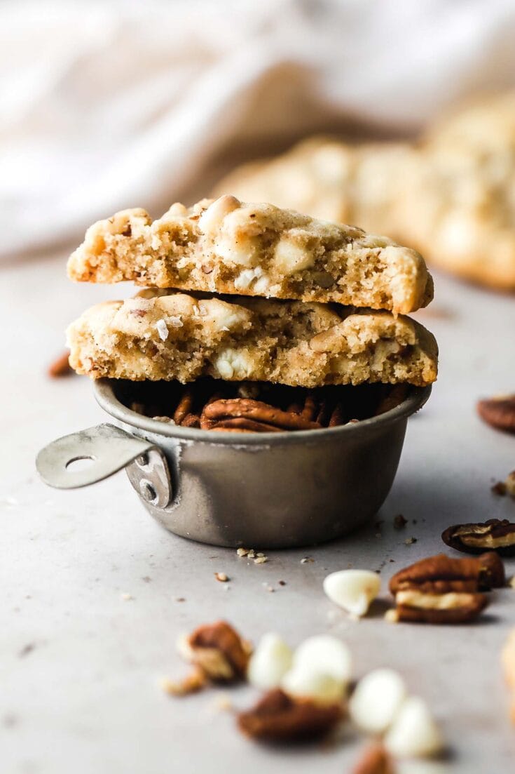 white chocolate chip cookies halves on top of pecans