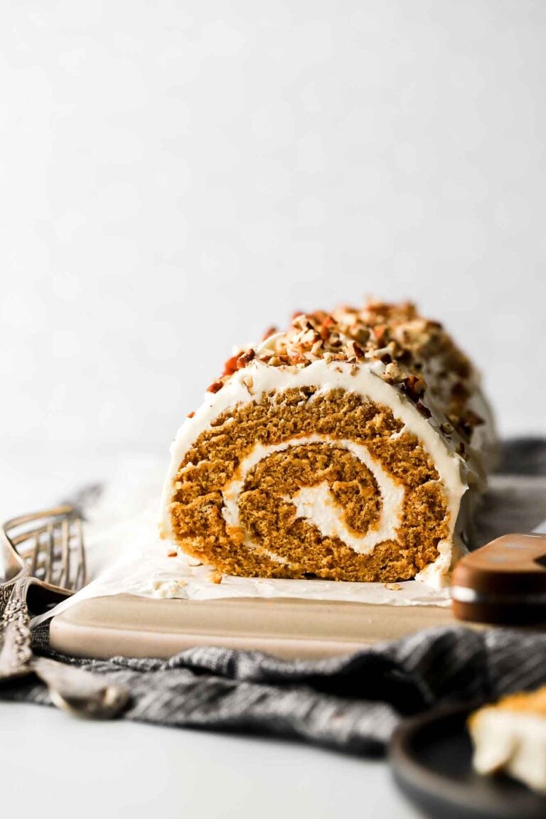Pumpkin roll with cream cheese frosting and pecans