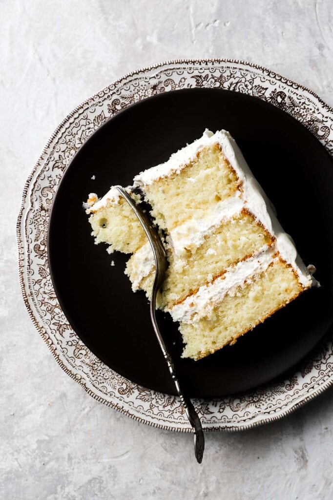 slice of a three layer 8 inch cake with a fork