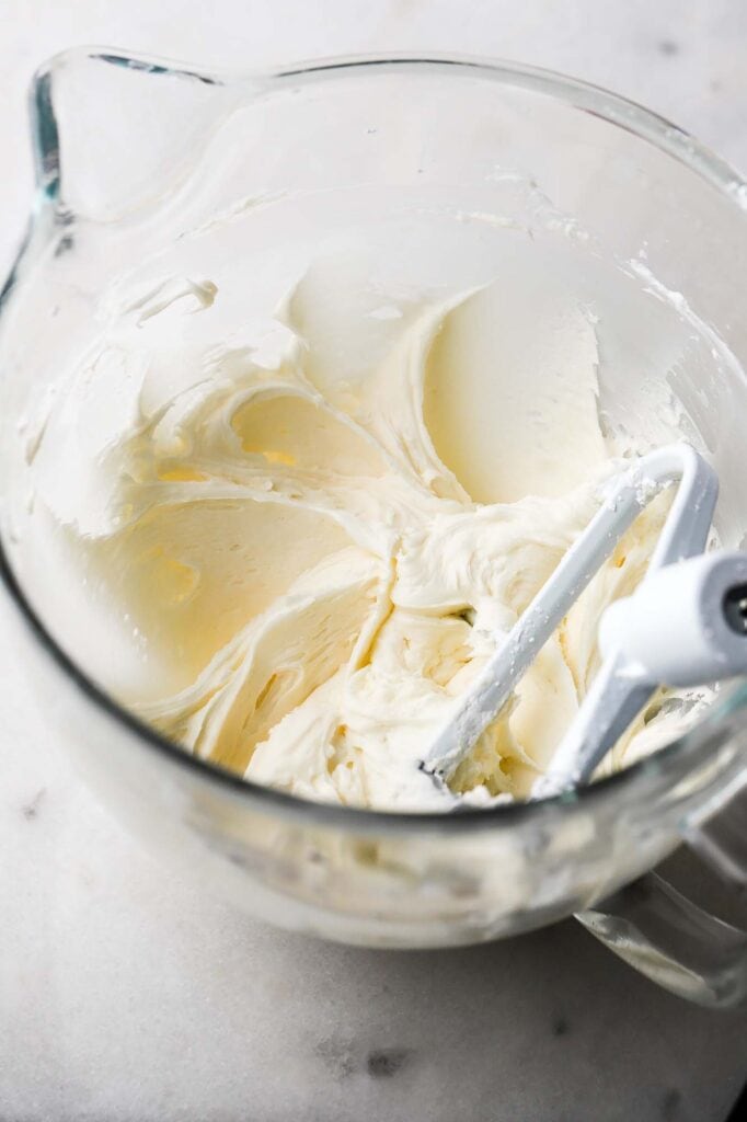 cream cheese frosting mixed in a bowl with paddle attachment