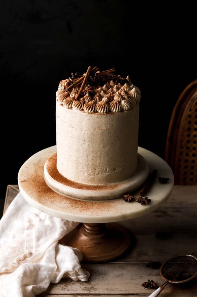 vanilla chai cake with puffs on top and cinnamon dusting