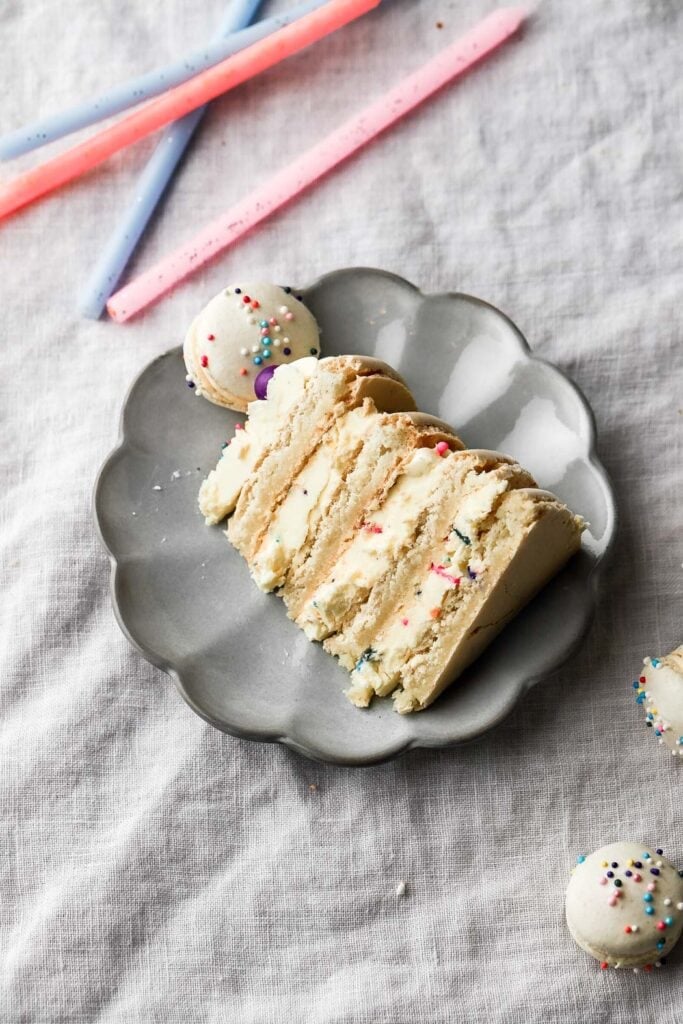 slice of macaron birthday cake on a plate