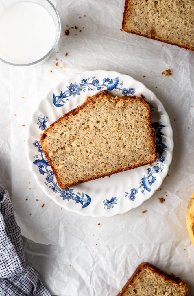 one slice of banana bread on a plate with milk