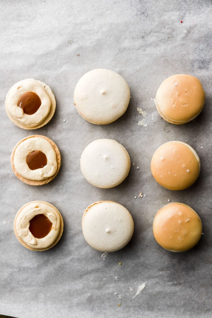 vanilla macarons with caramel french buttercream piped and a salted caramel filling