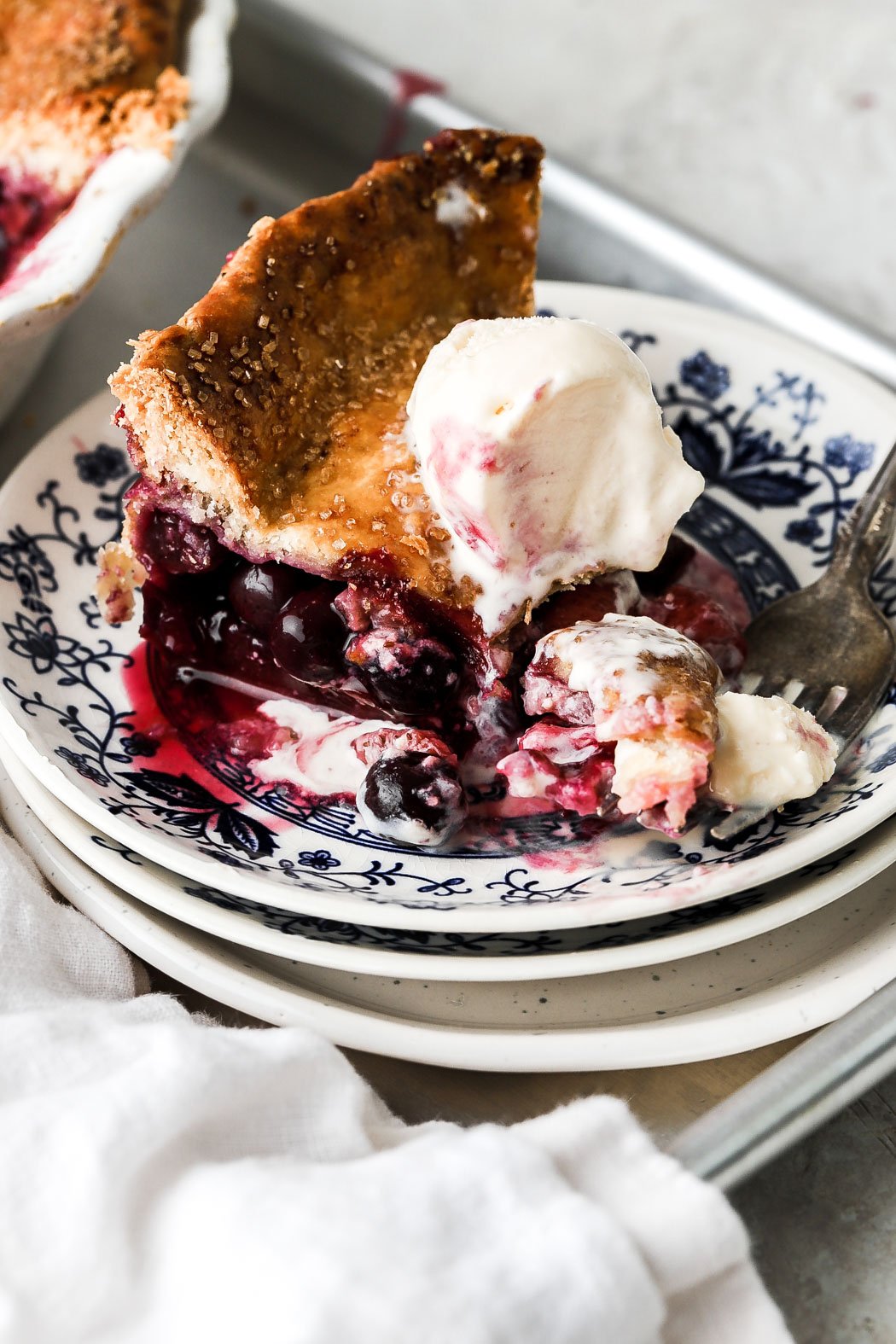 strawberry blueberry pie with vanilla ice cream on top