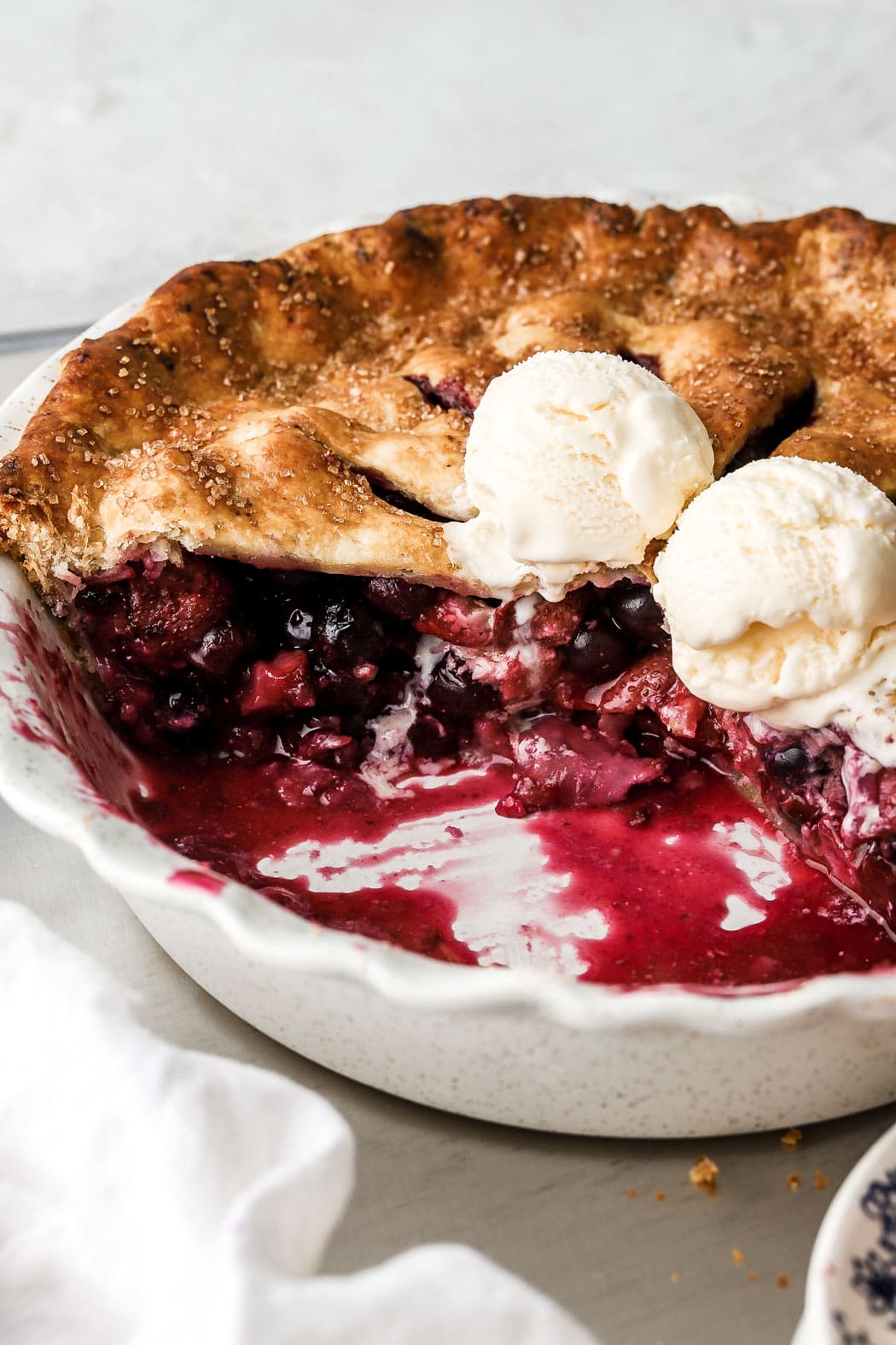 strawberry blueberry pie with vanilla ice cream on top