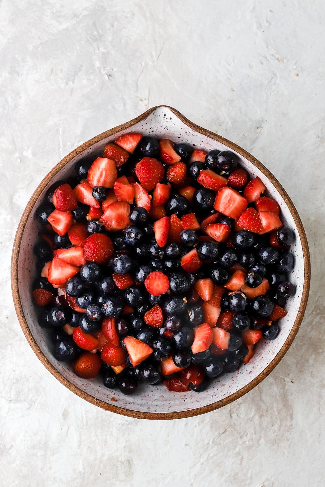 combine the strawberries and blueberries with sugar