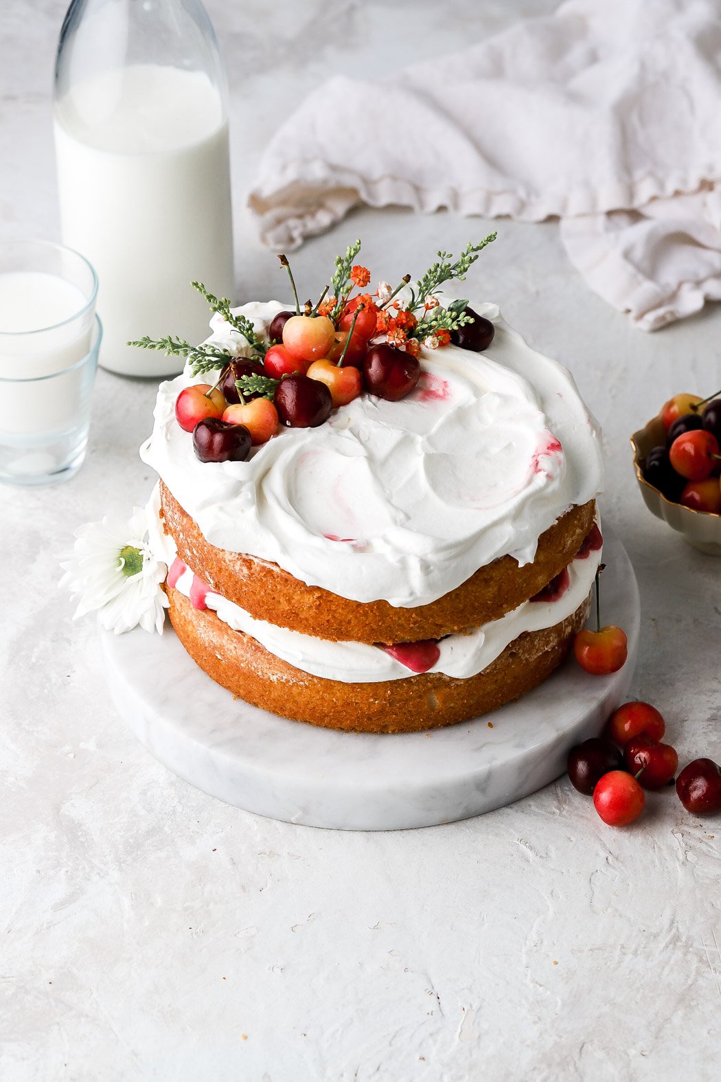 white forest cake with whipped cream and cherries