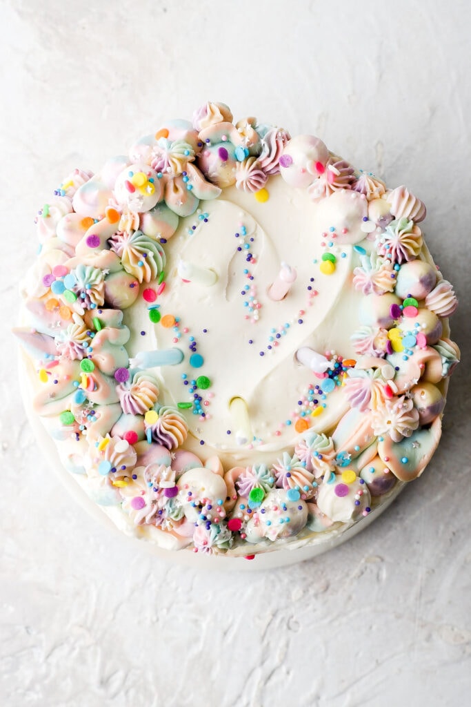 overhead of funfetti cake with piping and sprinkles on top 