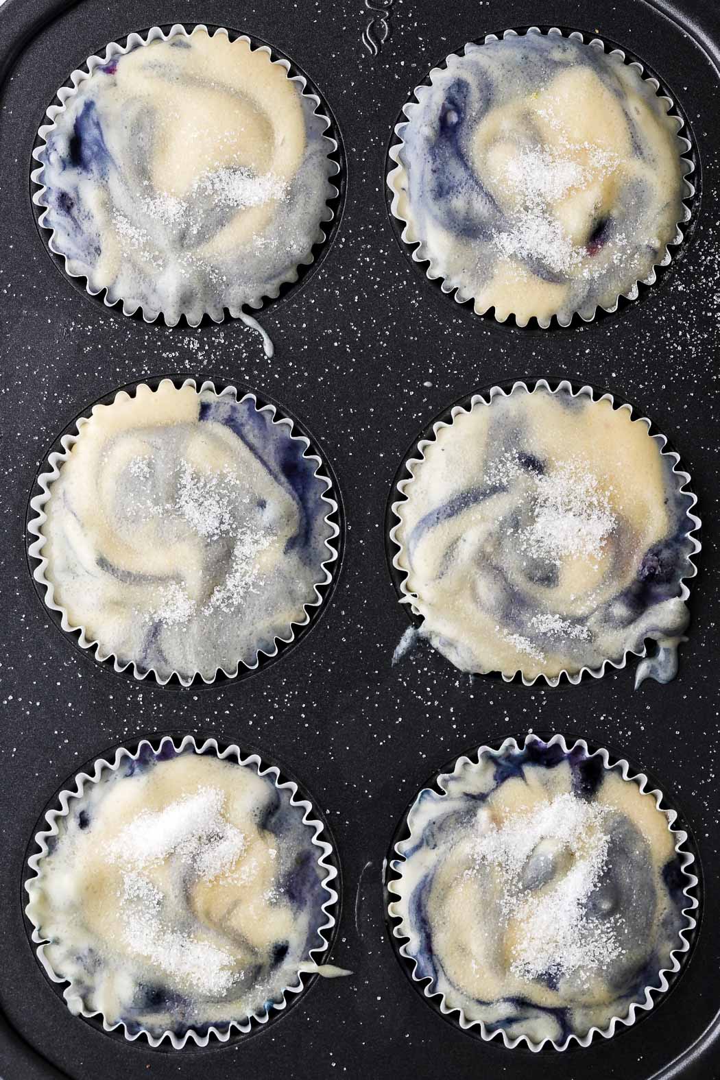 fill muffin tins all the way to the top and top with sugar