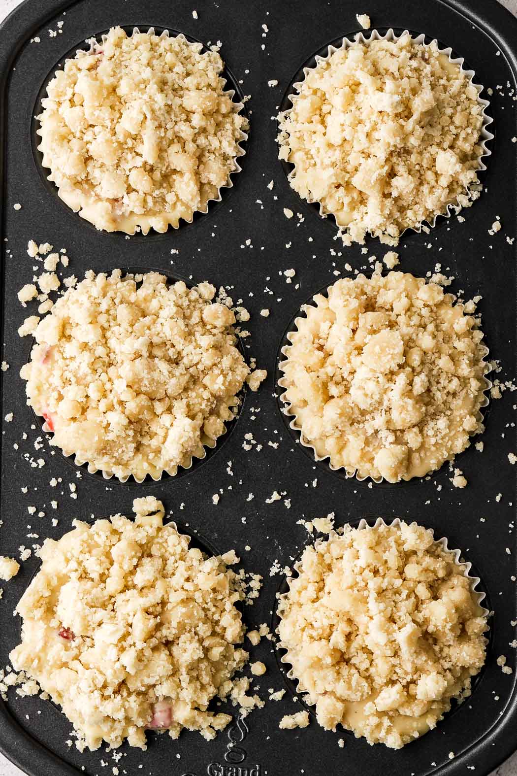 fill muffin tins to the top and top with streusel