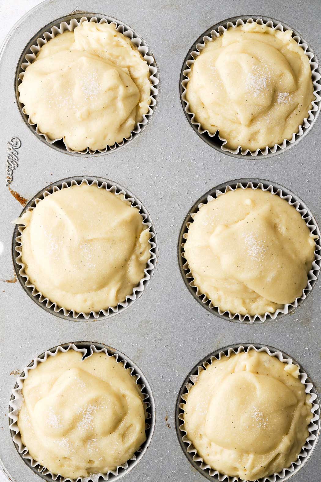 fill muffin tins all the way and top with sugar