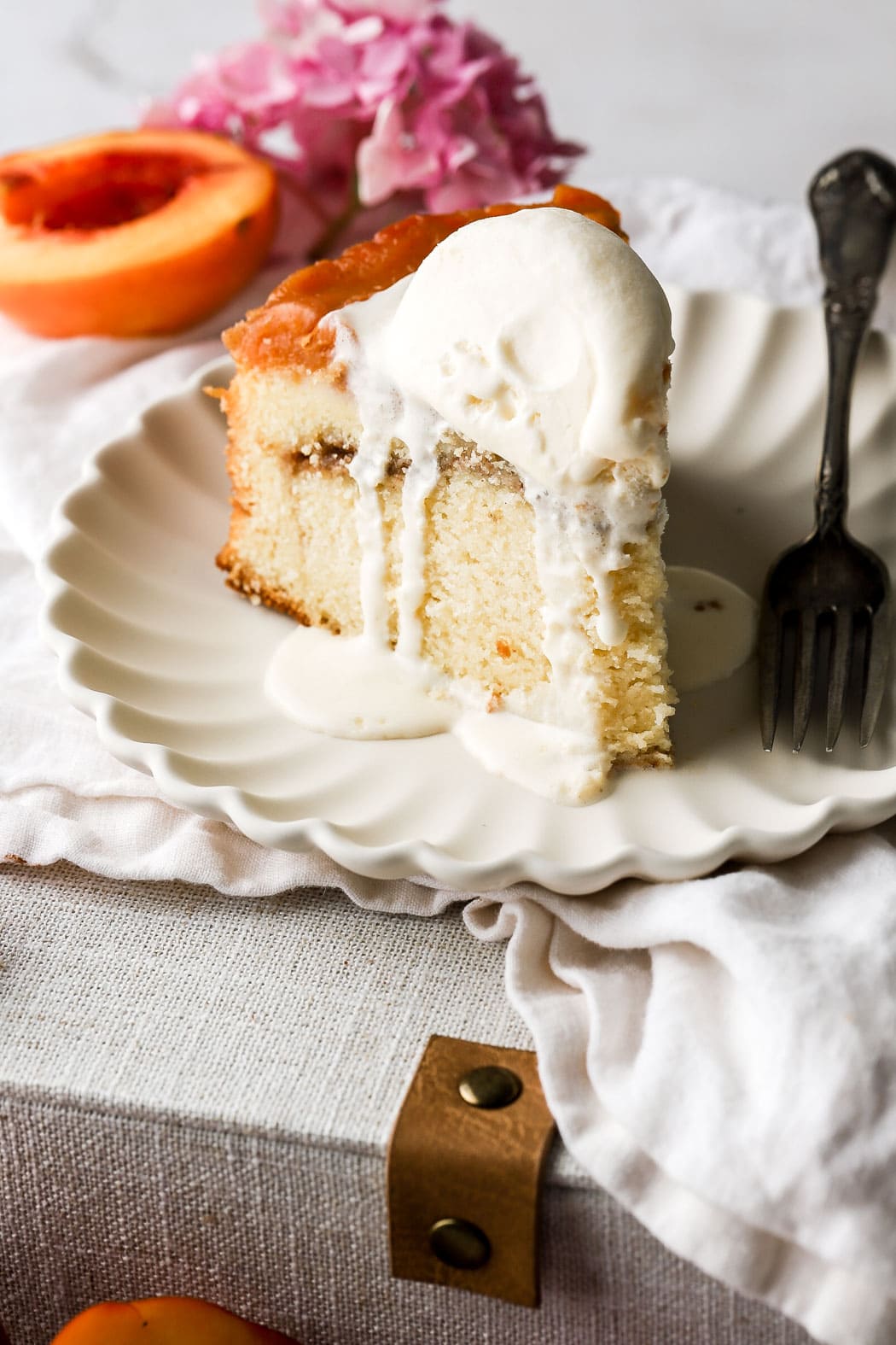 slice of peach cobbler pound cake with vanilla ice cream