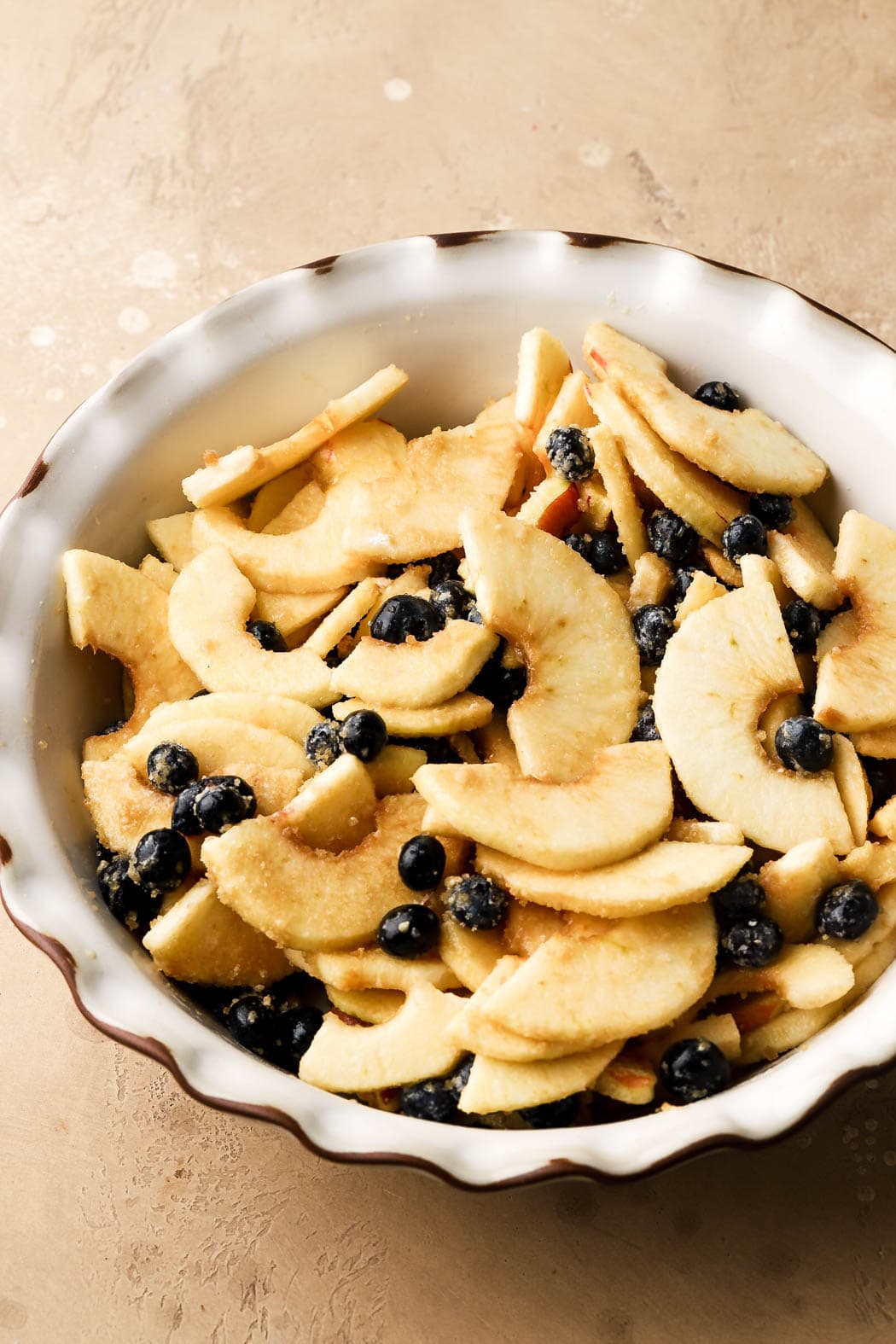 toss apples and blueberries with lemon, brown sugar, cinnamon and flour