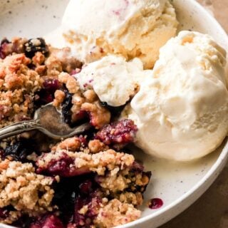 blueberry and apple crumble with vanilla ice cream