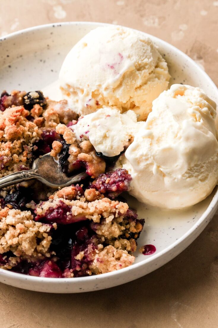 blueberry and apple crumble with vanilla ice cream