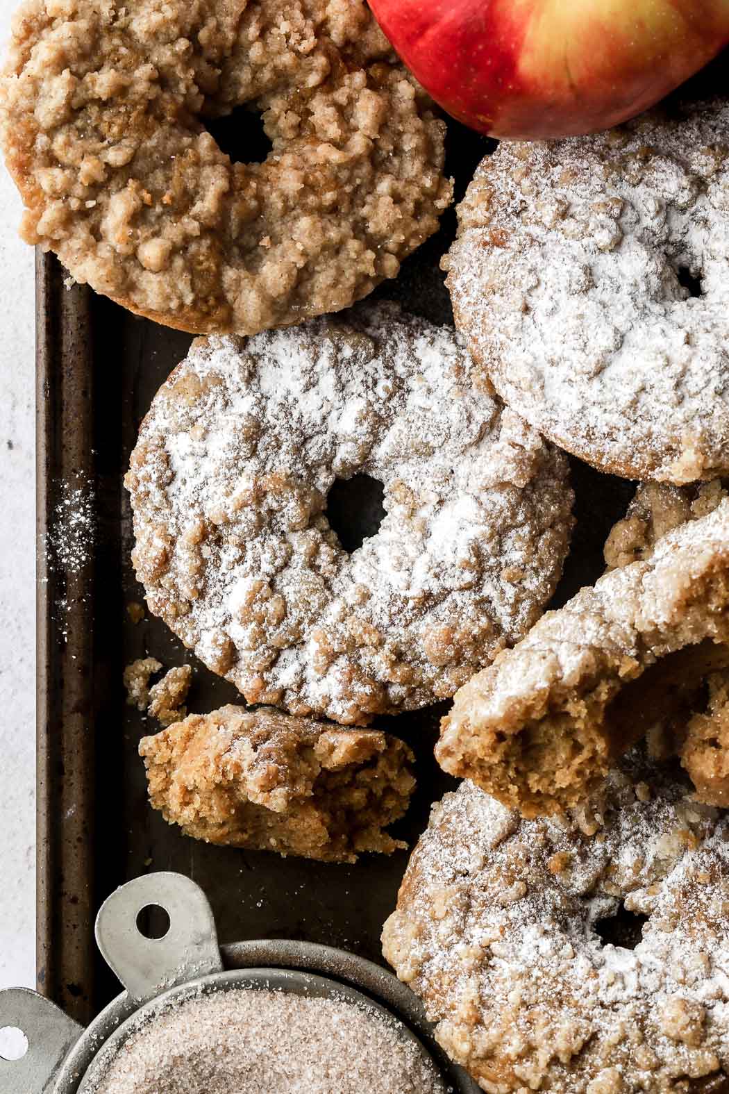 top apple crumb donuts with powdered sugar