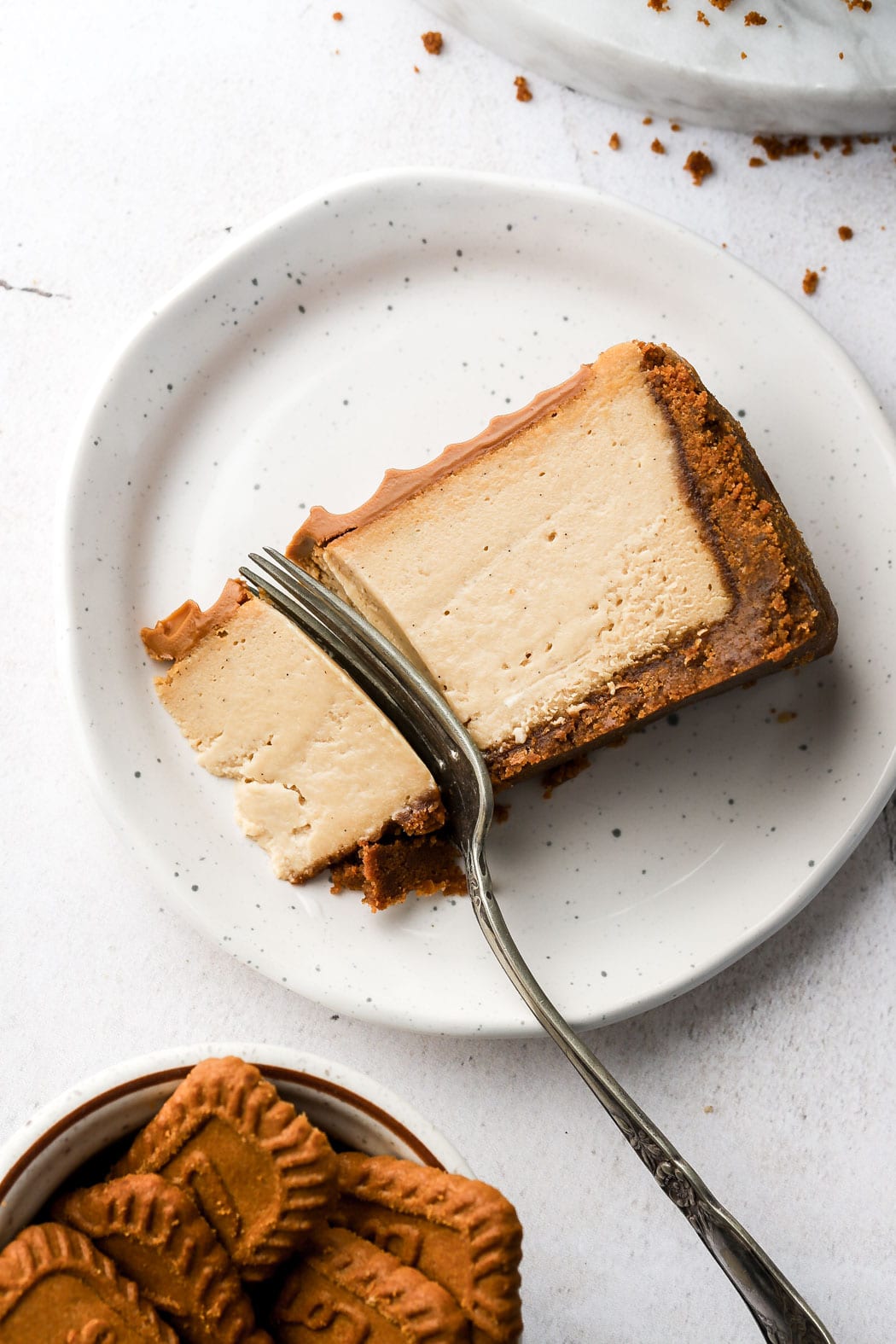slice of biscoff cheesecake on its side on a plate