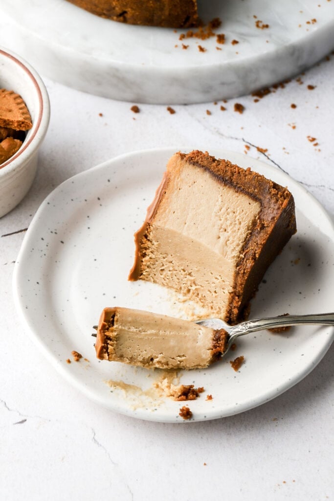 slice of biscoff cheesecake on its side with a bite on the fork