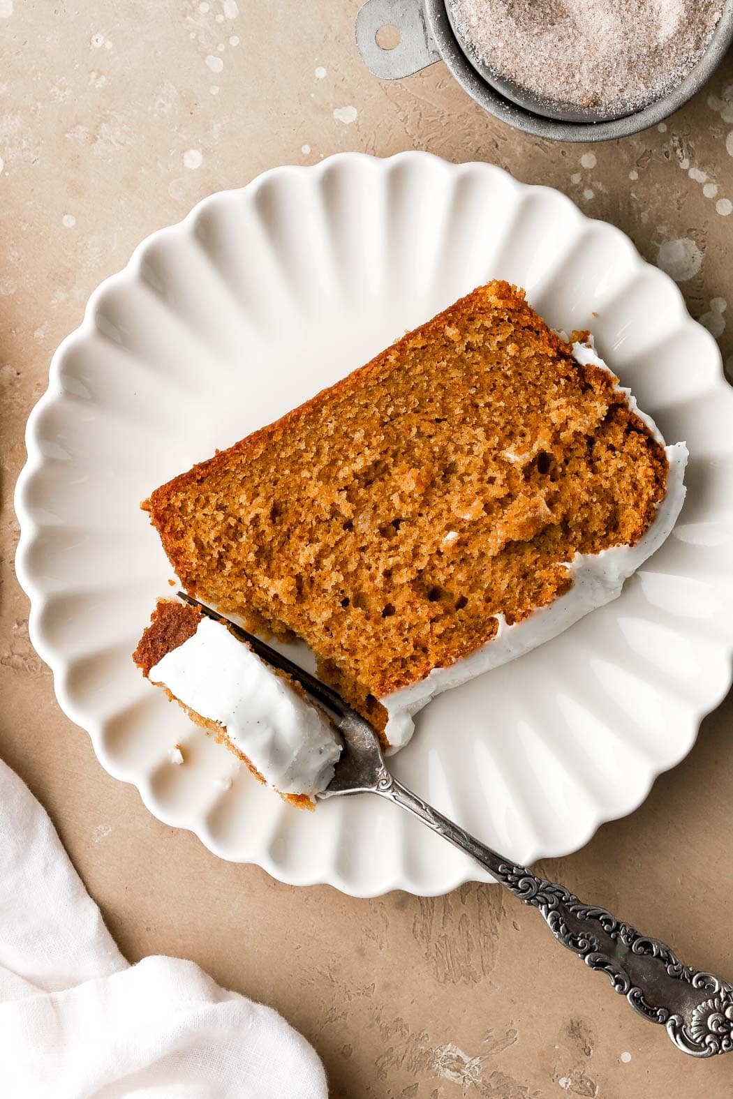 slice of pumpkin bread frosted with creaming cheese frosting