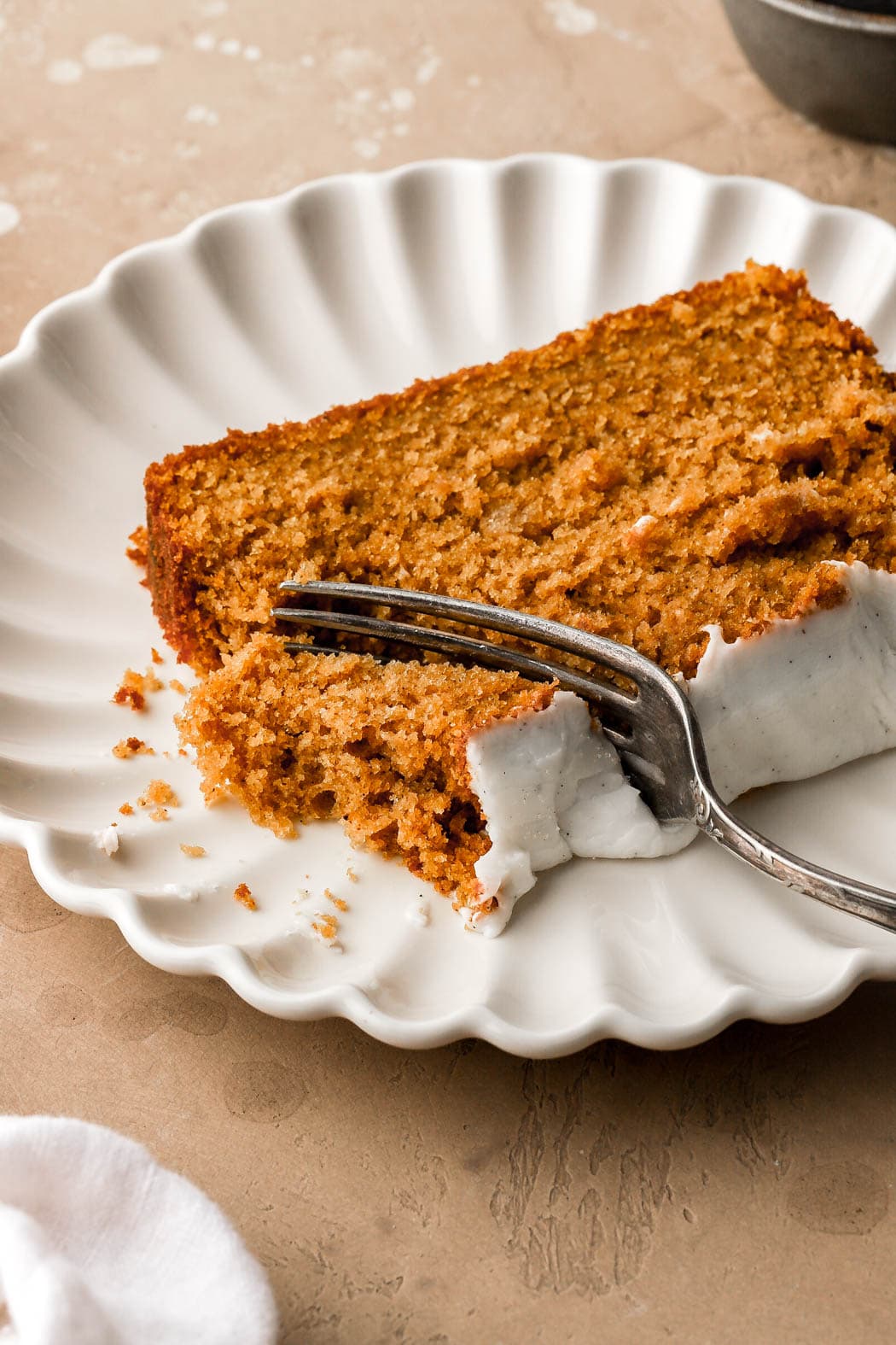 slice of pumpkin bread with cream cheese frosting