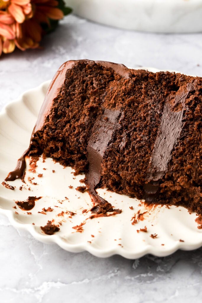 slice of chocolate ganache cake on a plate with a bite taken out