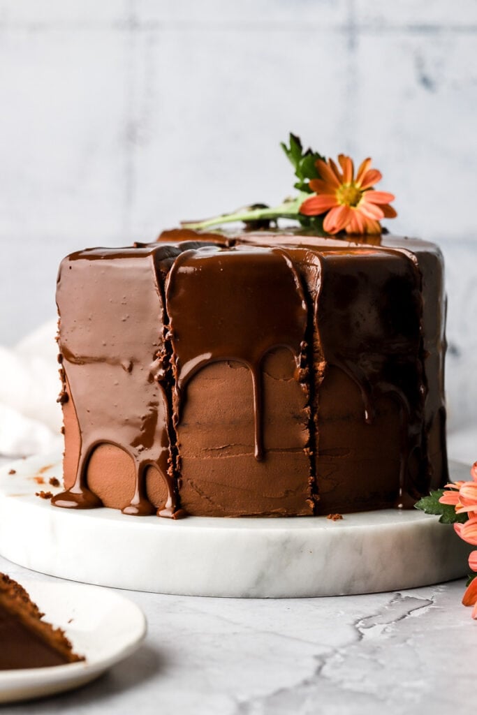 chocolate ganache dripping off the edge of a chocolate cake