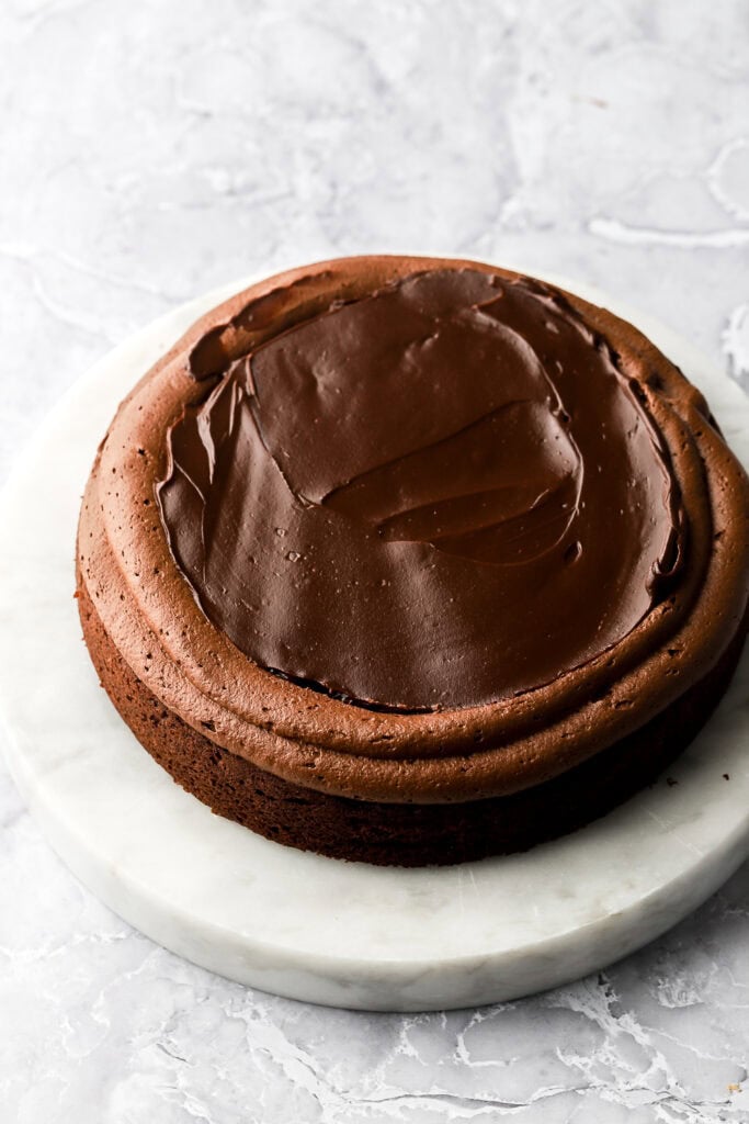 cake with a border of whipped chocolate ganache and filled in with un-whipped chocolate ganache