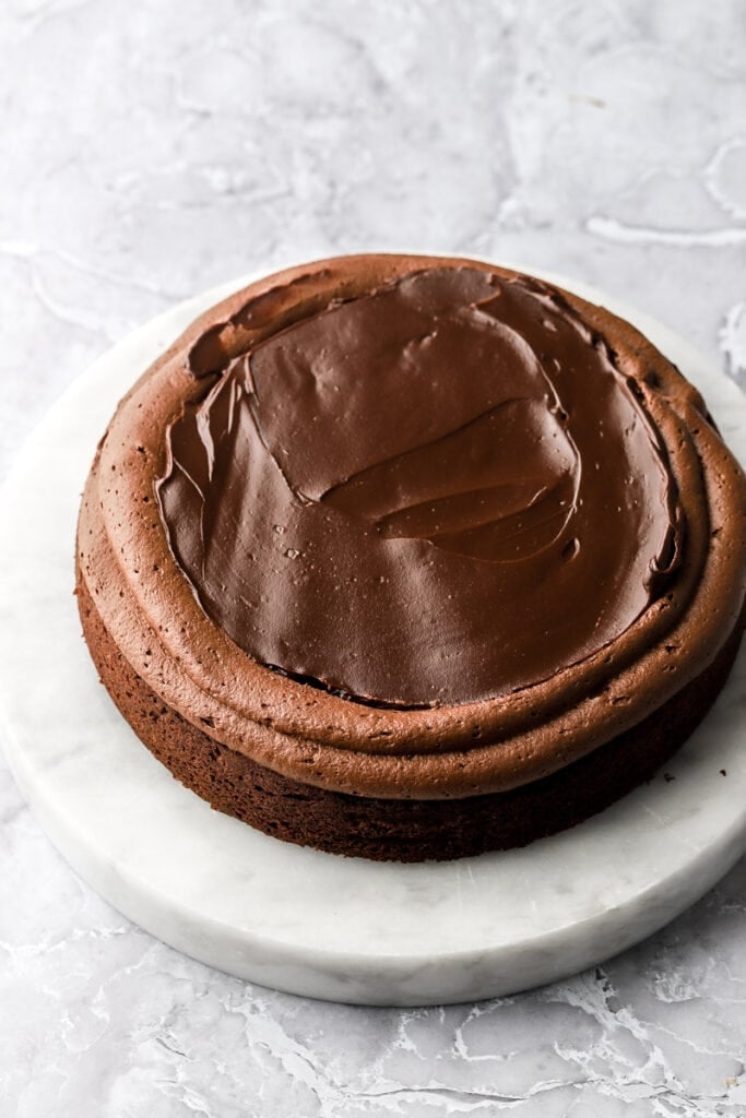 cake with whipped ganache as a border and unwhipped ganache as the filling