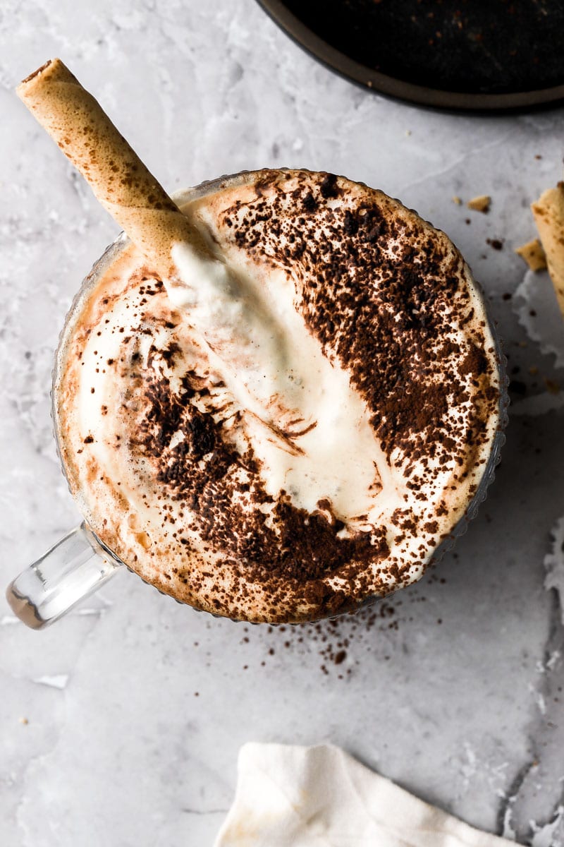 tiramisu latte in a cup with a cappuccino cookie