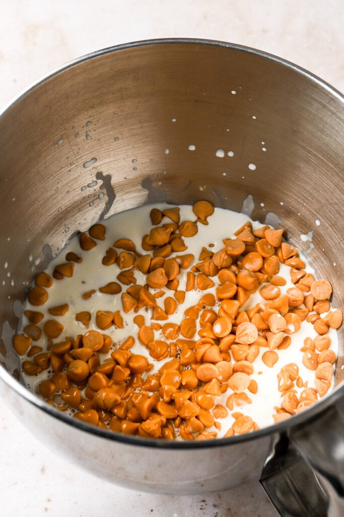 butterscotch chips in a bowl with hot cream